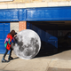 Illustration for article titled Artist takes her pet moon out for a walk